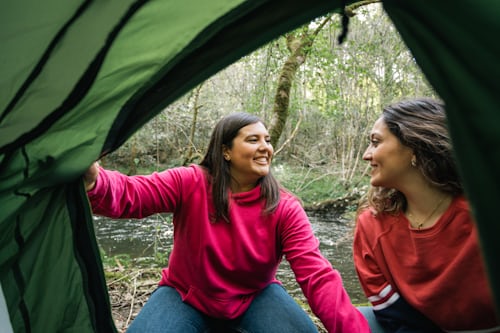 Beginner campers setting up tent - solo camping for two beginner tips